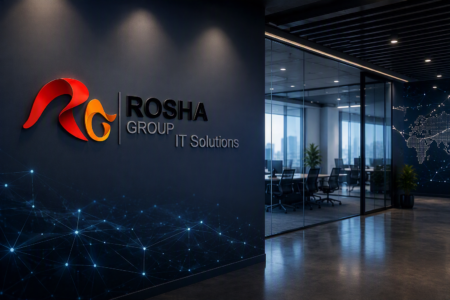 Corporate lobby wall featuring the Rosha Group IT Solutions logo in red/orange 3D letters, with a blue network-patterned mural and glass-walled offices to the right.